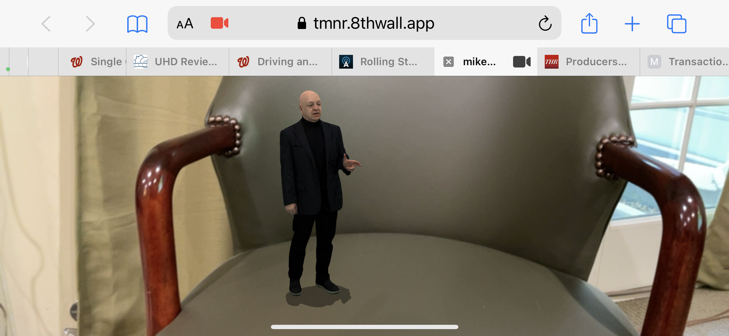 A hologram of USA TODAY's Mike Snider placed on a chair. Using augmented reality, the hologram can be placed in any real-world setting using a smartphone.